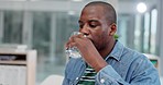 Black man in office on laptop, drinking water and typing report, review or article for online research. Computer, internet and employee with drink in glass, working at desk and checking email website