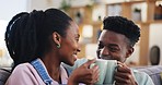 Coffee, toast and a happy black couple on a sofa in the living room of their home together. Tea, smile or cheers with a man and woman talking about love in their house while drinking a beverage