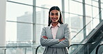 Face, smile and arms crossed with a corporate indian woman in an office or airport for an international trip. Portrait, happy and confident with a young employee in a business workplace for travel