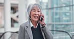 Talking, work and a mature woman on a phone call for business, networking or conversation. Office, morning and an Asian manager or company ceo speaking on a mobile for communication or discussion