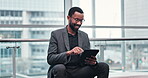 Company tablet, black man sitting and smile for customer experience review, target audience feedback or income data. Typing, scroll and relax African person happy for revenue, info or success insight