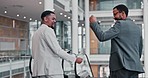 Fist bump, business men and success handshake at office escalator with teamwork and support from work. Smile, friends and motivation of web analyst workers back with celebration from collaboration