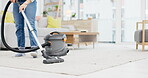 Carpet, vacuum cleaner and a person in the living room of an apartment for hygiene or housework. Cleaning, housekeeping or chores with an adult using an electronic appliance in the home closeup