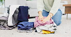 Fold, laundry and hands on clean clothes pile in house and woman on living room floor or housekeeper spring cleaning. Washing, basket and order stack of clothing or person working in home service