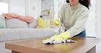 Cleaning, home and woman with a cloth, spray bottle and dust with bacteria, table and disinfectant liquid. Person, housekeeper and cleaner with hygiene, germs and dirt with maid and chemical to wipe