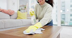 Headphone, music and woman spring cleaning on a table in home living room as for hygiene, protection or disinfection. Dirt, dust and person or cleaner doing domestic or sanitary housekeeping work