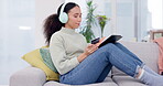 Woman, headphones and credit card on tablet and sofa for music streaming subscription, e commerce or online shopping. Young african person on digital technology, listening to audio and home banking