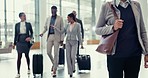 Business woman, travel and corporate staff walking in a airport lobby for work trip. Suitcase, company people at a terminal lounge for commute with journey luggage and bag ready for a job conference