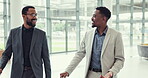 Travel, suitcase and business men walking in an airport together for an international flight while talking. Corporate trip, collaboration and a professional man talking to a colleague in a hotel