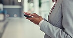 Business person, phone and hands typing in communication, social media or networking at office. Closeup of employee texting, chatting or scrolling on mobile smartphone or online app at the workplace