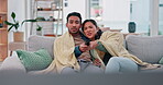 Couple, watching tv and fight on a home sofa with a remote control for choice and relax. Asian man and a woman together on a couch for streaming subscription, show or movies with a blanket and care