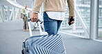 Back, walking and hands on suitcase in airport to travel, vacation or holiday in airline lobby. Luggage, person and rear of man on flight terminal, immigration journey or international airplane trip