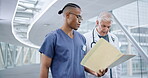 Folder, teamwork of doctor and nurse walking in hospital lobby, discussion or communication. Collaboration, documents and people, surgeon and medical professional in healthcare, planning or talking