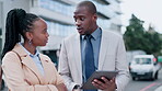 Business people, talking and planning outdoor with a tablet in a city for collaboration, networking or advice. A black man and woman on an urban road with technology for discussion, search or ideas