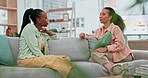 Discussion, relax and girl friends on sofa speaking in the living room of their modern home. Conversation, happy and young gen z women talking, gossip and bonding together in the lounge of apartment.