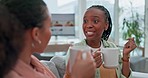 Coffee, conversation and girl friends on a sofa talking, bonding and relaxing in the living room. Communication, gossip and young women drinking tea and speaking in the lounge together at apartment.