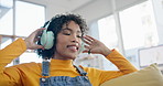 Music, happy and dance with woman on sofa for streaming, relax and energy. Freedom, media and online radio with person listening to headphones in living room at home for technology, sound and audio