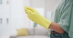 Cleaning, gloves and hygiene with hands of person in living room for sanitary, housekeeping and bacteria. Safety, health and dust with closeup of cleaner at home for protection, product and germs