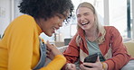 Smartphone, lesbian couple and funny women in home living room, interracial comedy and meme on internet. Phone, gay girls and laughing at joke on social media, video and website together on sofa.