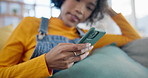 Phone, social media and app with a woman on a sofa in the living room of her apartment for communication. Mobile, contact and relax with a young person typing or reading a text message in her home