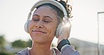 Dance, happy and a woman with music in the city, listening to the radio and technology in summer. Smile, relax and a girl or person with headphones for sound, streaming and hearing audio or podcast