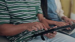 Hands, tablet and couple on a sofa in the living room of their home together closeup for research or gaming. Technology, social media or website with a man and woman bonding in their house to relax