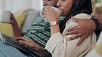 Couple, laptop and hug with coffee in home for love, watch movies and streaming multimedia. Hands of man embrace woman while drinking tea at computer for social media, web download or online shopping