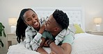 Happy black couple in bed with playful embrace, love and relax on weekend morning in home. Smile, hug and fun, African man and woman in bedroom together, laughing and bonding in apartment with care.