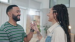 Dance, funny and a couple laughing in the living room of their home together for romance closeup. Face, love or comedy with a man and woman moving to music in their house to relax for happy freedom