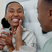 Happy, holding hands and a black couple in bed with coffee ...