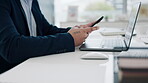 Hands, workspace and a phone of a person for social media, communication or typing an email. Desk, office and an employee with a mobile at work for a chat, online contact or working on technology