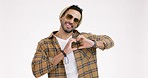 Fashion, hands in heart and man in studio with trendy clothes, style and sunglasses. Happy, relax and portrait of isolated hipster person with hand gesture, love symbol and emoji on white background