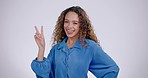 Woman, face and peace sign in studio with a smile from laughing and v hand gesture. Grey background, comic and female person with portrait and excited with casual fashion and happy emoji hands