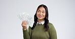 Money fan, finance and woman with dollars, wealth and bonus with bills isolated on white background. Happy, confident and financial freedom with cash, notes and prize, lottery and cashback in studio