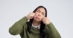 Fake, crying and woman face in studio with hands gesture for sad, bullying or gesture on grey background. Tears, face and female joke, cry and sign on mockup with unhappy boo emoji or fist of loser 