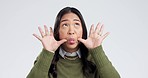 Happy, goofy and face of Asian woman in a studio with funny, comic or funny facial expression. Playful, comedy and portrait of a young female model with silly personality isolated by white background