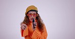 Young woman, cellphone and singing in studio, face and happy in funny performance by white background. Gen z girl, artist and phone for music, voice or recording in portrait, dance or pointing at you