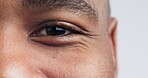 Eye, vision and iris with portrait of black man in studio for zoom, healthcare, optometry or retina. Human, contact lens and exam with closeup of person on white background for medical and eyeball