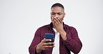Phone, wow and black man in studio reading fake news, comment or social media on white background. Wtf, gossip and African model surprise by drama, secret or scam, feedback or stress for announcement