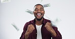 Black man, money rain and celebration in studio, winner and happy for success, gambling or goal by white background. African investor, trading and cash in air for profit, bonus or lottery with smile