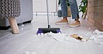 Broom, trash and closeup of woman sweeping in the living room of her modern apartment for hygiene. Equipment, dirt and zoom of female maid or cleaner cleaning the floor with dirt in lounge of a house