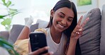 Peace sign, selfie and happy Indian woman on sofa take photo for social media, online post and blog. Home, relax and person with hand gesture for profile picture, internet and memory in living room