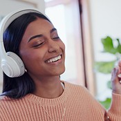 Dance, headphones and young woman in the living room listening to music ...