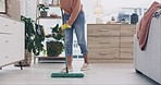 Person, mopping and cleaning living room floor in house hygiene, dirt and bacteria safety in housekeeping routine. Wipe, cleaner or equipment for ground dust control, disinfection or germs protection