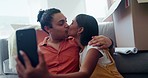 Selfie of happy couple in new house with boxes, kiss and excited in property, investment and mortgage. Moving, man and woman embrace on living room floor, photography and love at young marriage start