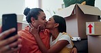 Selfie of couple in new home with boxes, kiss and excited in property, investment and mortgage. Moving house, man and woman embrace on living room floor, photography and love at young marriage start.