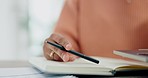 Hands, pen and closeup for paperwork, laptop and thinking with notes, budget and ideas with choice at desk. Person, accounting and audit for financial review, planning and decision with documents