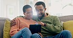 Internet, search and couple on a sofa with tablet, hug and conversation in their home together. Love, chat and black woman with man in a living room online for streaming, subscription or social media