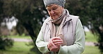 Old woman, hands and pain with arthritis and health, muscle or joint ache, massage and tension while outdoor. Retirement, pension and medical emergency, inflammation and tendinitis with sprain