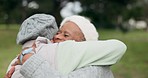 Smile, care and senior friends hugging in a park for bonding on a walk for fresh air together. Nature, happy and elderly women in retirement embracing for love, connection or reunion at a garden.